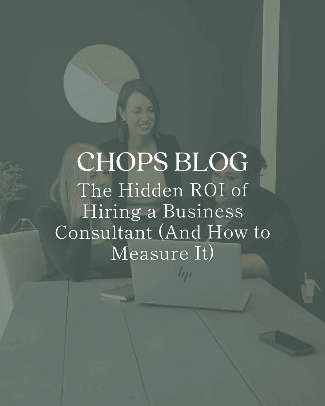 3 female business consultants sitting/standing behind a table, behind a laptop and looking engaged